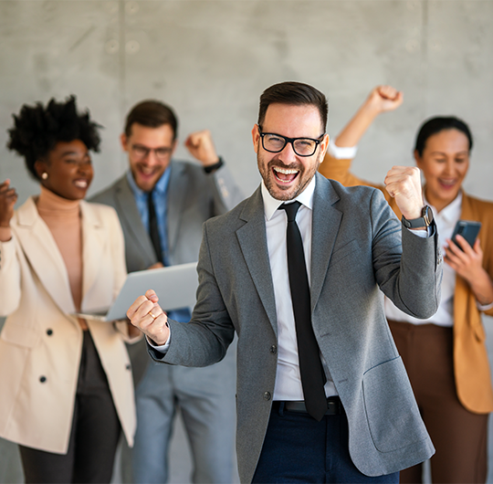 Team of IT professionals celebrating success representing client results and innovation at RainTech