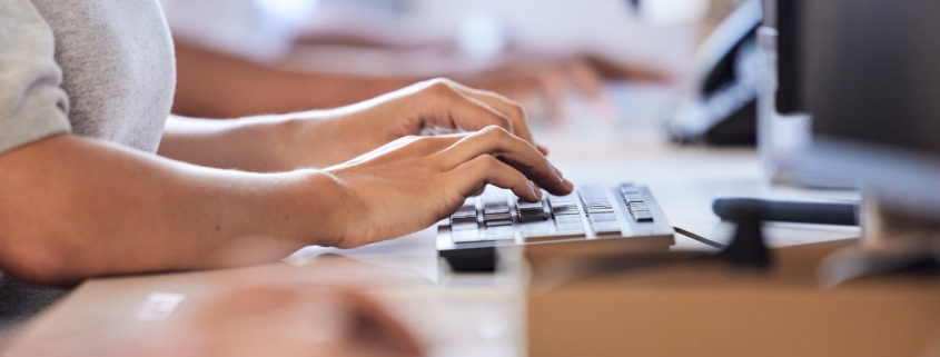 Person typing at there computer for rain tech